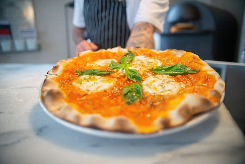 Classic Margherita pizza factory style with fresh mozzarella and basil